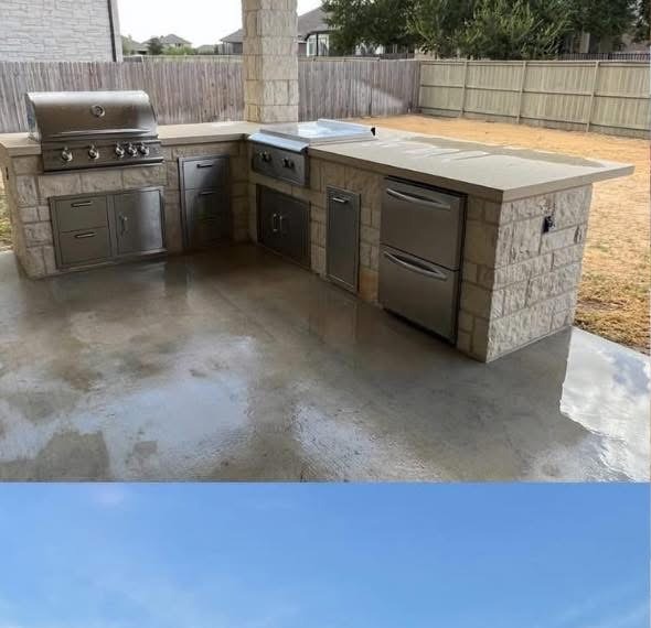 Stone outdoor kitchen with stainless grill