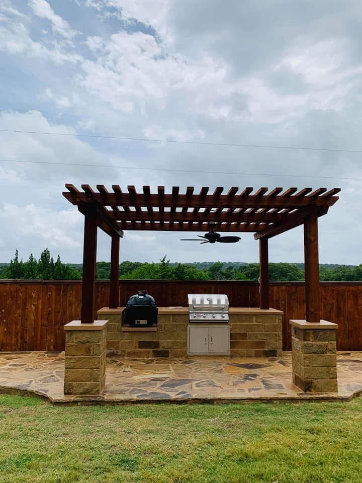 Wood pergola over stone outdoor kitchen